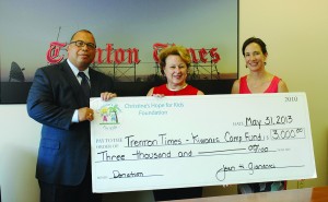Photo Caption: From left, Times-Kiwanis Camp Fund Chairman Alex Treece accepts a ceremonial check from Jean Gianacaci and Laurie Stewart of the Christine's Hope for Kids Foundation.  Credit: Gaylen Gallimore/For The Times